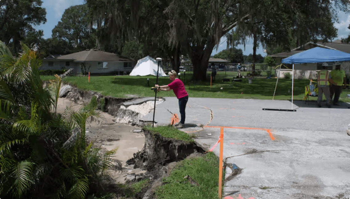 Dr. Lori Collins collecting subsurface data from the sinkhole using GPR technology